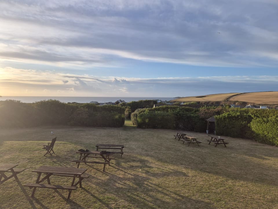 Golden-hour view over the sea-view lawn toward the bay
